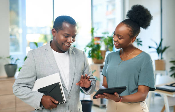 istock Business, black people and tablet in office, conversation and website launch with smile, schedule or deadline. Employees, staff or coworkers with teamwork, digital planning or discussion in workplace 1468487785
