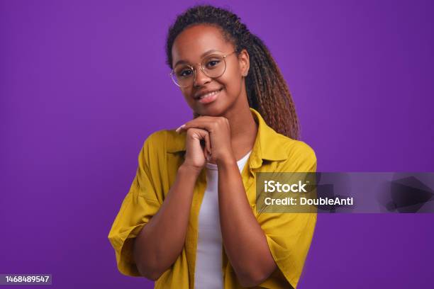Young Goodnatured African American Woman Looks At Camera With Chin On Hands Stock Photo - Download Image Now
