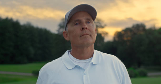 istock Senior golf player rest on sunset nature. Active elderly stand on summer course. 1468491601