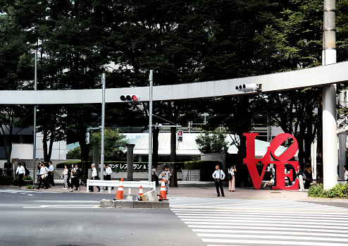Tokyo, Japan - Sept, 2017: Nishi Shinjuku LOVE Statue with crosswalk A meeting place in Nishi-Shinjuku. A symbol of Shinjuku i-LAND and its message of love