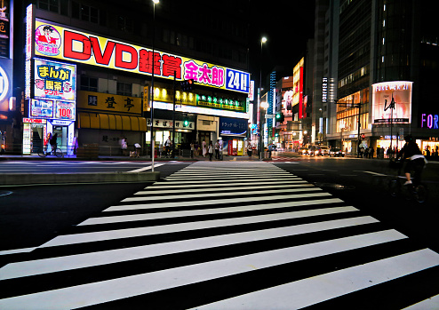 Tokyo, Japan - Sept, 2017:  Kabukicho crossing, red-light and nightlife entertainment district, Shinjuku crowded with tourists during the night with neon billboard and advertisements in background