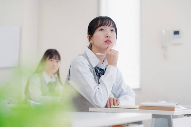 istock High school girls thinking in the class 1468496974