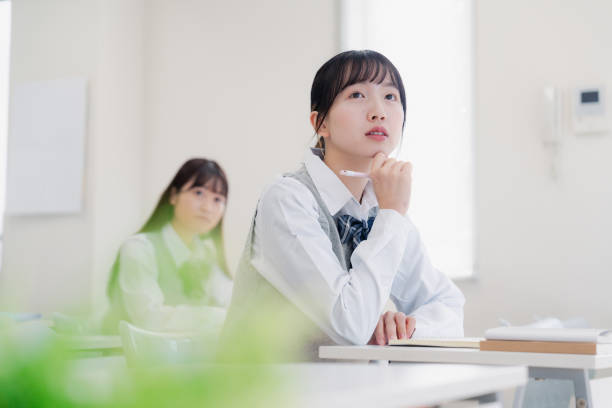 istock High school girls thinking in the class 1468496981