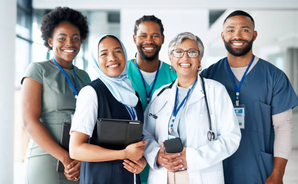 Portrait, diversity and happy team of doctors with teamwork excited, positive and proud in a hospital or clinic. Group, healthcare professional and medicine or medical experts in unity together stock photo