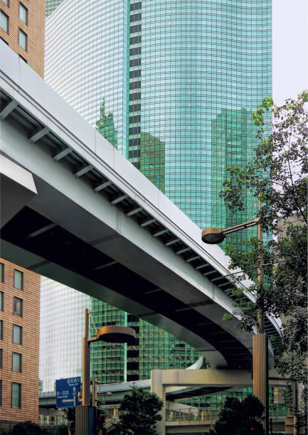 Tokyo, Japan - Sept, 2017: Yurikamome line, an elevated and automatic monorail train and Shiodome City Center facade reflecting. Shiodome skyscrapers in Shimbashi district Minato City