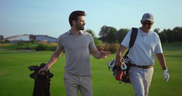 istock Successful golfers smiling discuss golf on course. Two men enjoy sport action. 1468497685
