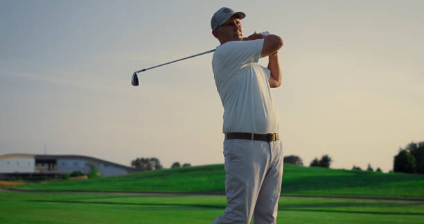istock Golf player teeing club putter on sport training. Rich man on luxury vacation. 1468498245
