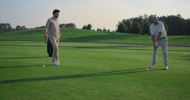 istock Golfing team play sport on course. Golf group practicing hits in country club. 1468498932