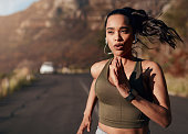 Breathe, music and woman running in the street for fitness, training and marathon in the mountains. Sports, workout and runner in the road with a podcast while doing an outdoor exercise in Germany