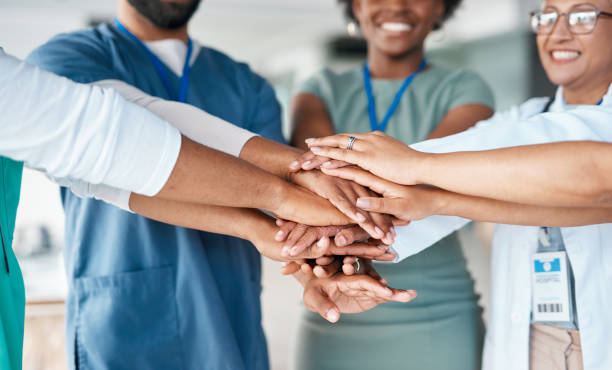 Hands together of doctors and nurses in healthcare teamwork, solidarity and support in hospital diversity. Workflow of medical people, staff or employees in hand stack goal for happy clinic workforce stock photo
