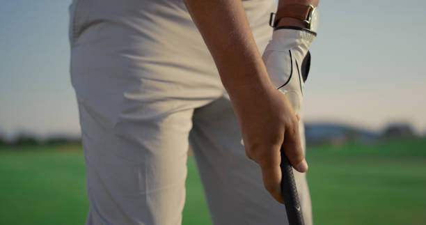 istock Guy hands playing golf on sunset country club. Golfer hitting ball using putter. 1468500178