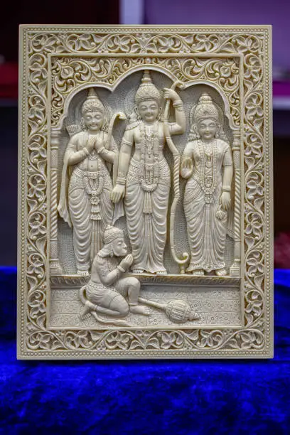 Picture of a stone sculpture of Hindu god lord Rama, Lakshmana, Sita and Hanuman idols displayed in a shop for sale in blurred background. Indian art, culture, tradition and handicraft.