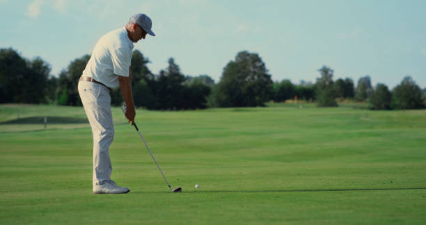 istock Professional athlete playing golf outdoors. Man walking golfing course in summer 1468501757