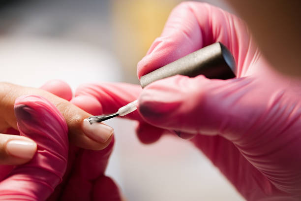istock Nail artist in beauty salon making manicure for client 1468504830