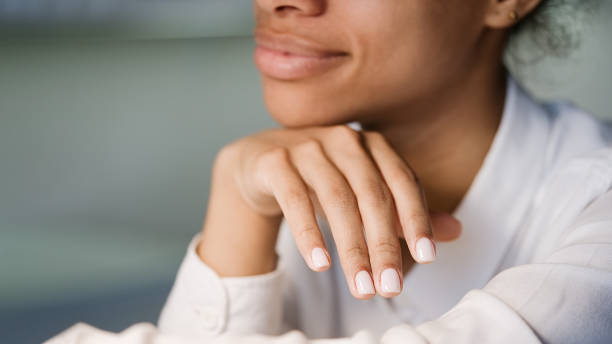 Nail artist in beauty salon making manicure for client