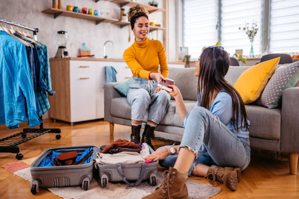 istock Two Female Friends Packing For A Trip 1468507074