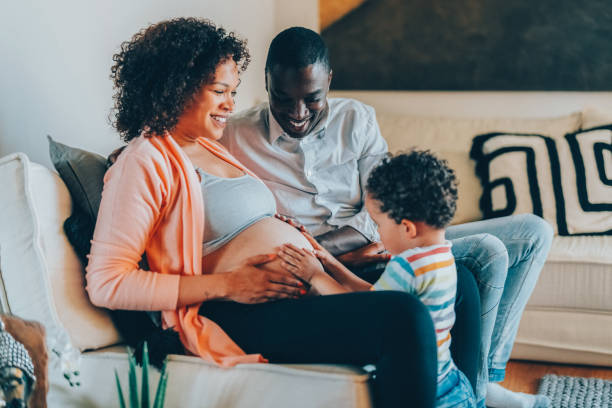 istock Boy with hands on mother’s belly feeling the baby’s movements and kicks 1468507811