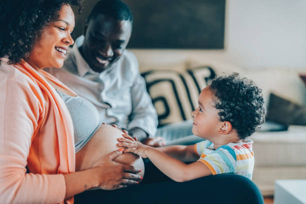 istock Boy with hands on mother’s belly feeling the baby’s movements and kicks 1468508098