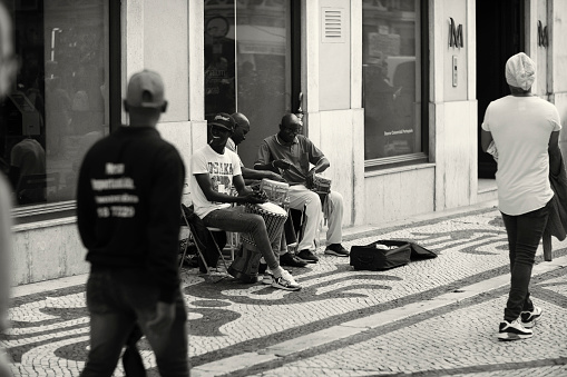 Lisbon, Portugal- October 29, 2022: A trio of street musicians pla percussion at the Rua Augusta street in Lisbon downtown.