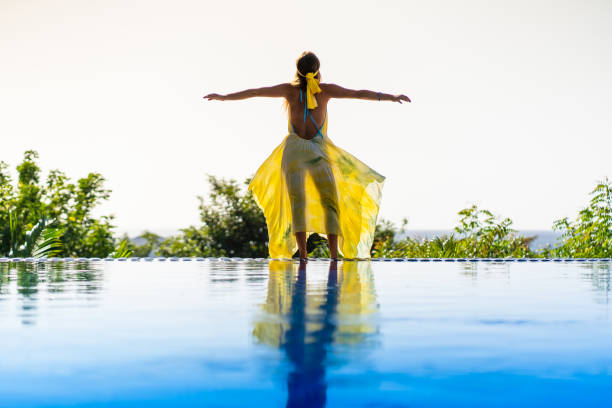 istock Rear view of a model standing on an outdoor pool 1468511211