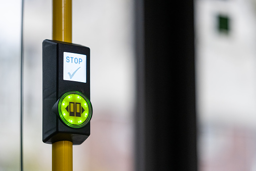 Close-up of stop button in city bus.