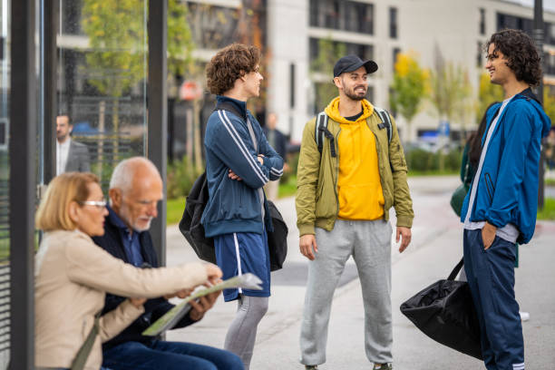 istock Friends standing near bus stop 1468513688