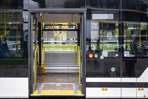 Empty bus with open door in city.