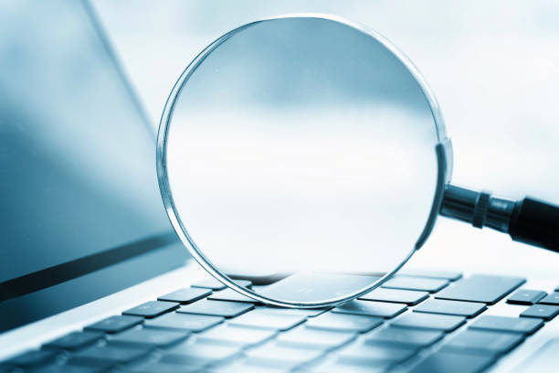 istock Magnifying glass on the laptop keyboard 1468514098