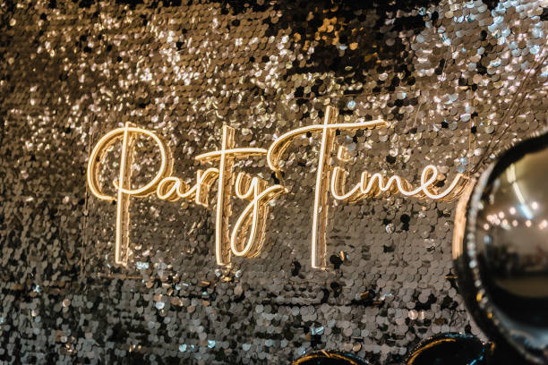 istock Silver photo booth with decor shiny and led strips with text party time. Zone with sparkling sequins. Glittery festive wall for wedding. A place for congratulations on birthday. Happy New Year 2023. 1468514359