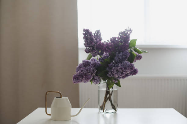 istock Home interior decor, bouquet of lilacs in a vase on table 1468514438