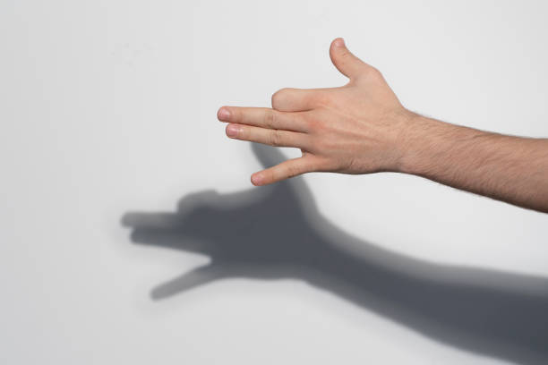 istock human hand making the shadow of dog on the wall 1468514609