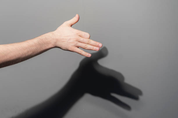 istock human hand making the shadow of dog on the wall 1468514611