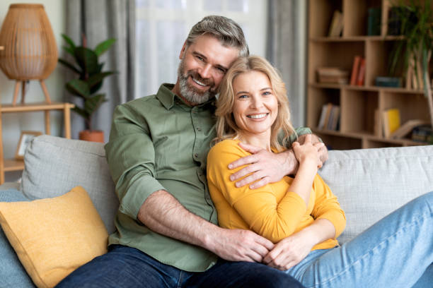 istock Happy Middle Aged Spouses Relaxing On Couch At Home And Hugging 1468516621