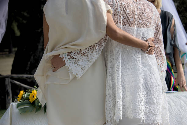 close-up embrace two half-bust lgbt q plus people together at a happy wedding