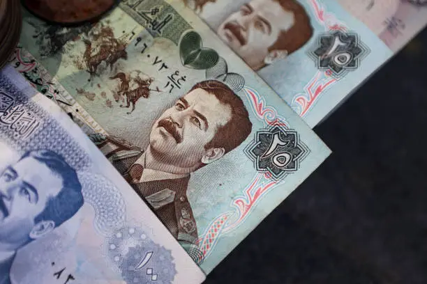 Group of old Iraqi Dinar banknotes with Saddam Hussein, perfect for backgrounds.
