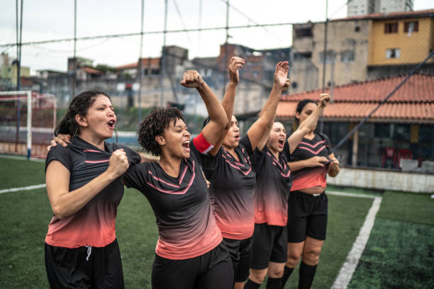 istock Happy female soccer team celebrating 1468518819