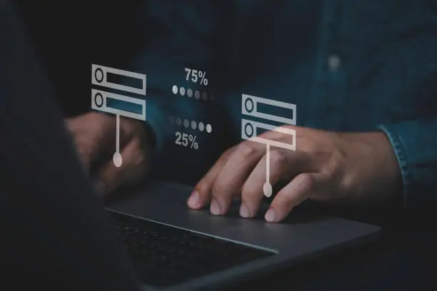 Photo of Businessman hand using laptop computer with data host server storage icon for information exchange and transfer concept.