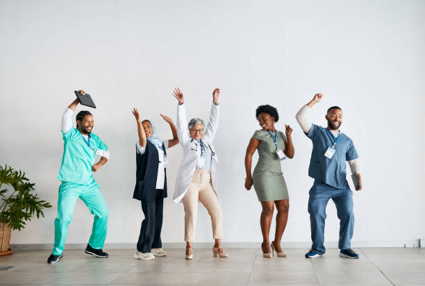 Winner, dance and successful and happy doctors winning with mockup space feeling happy, excited and joy. Teamwork, group and healthcare professional workers or colleagues with motivation for about us stock photo