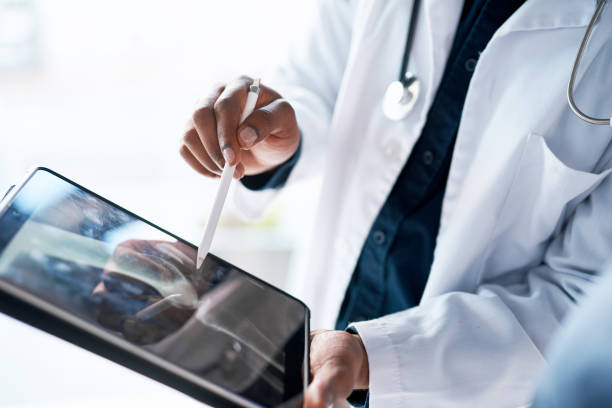 Tablet, doctor hands and digital x ray results of hospital, wellness clinic and medical worker. Tech, mri and bone assessment of a consulting professional with online xray on screen for analytics stock photo