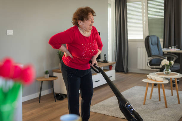 istock Senior woman crying of backache while she is vacuuming home 1468521736