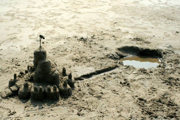 istock Sand castle with a pond on the sea shore 1468522252