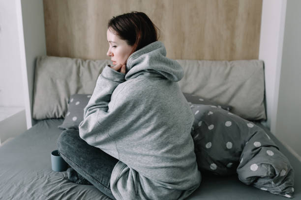 morning, coziness, cozy home concept - a young woman with cup of coffee or cacao in bed at home - 11911 imagens e fotografias de stock