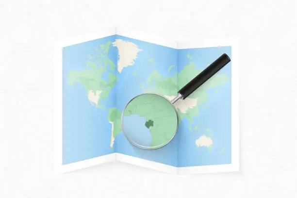 Vector illustration of Enlarge Gabon with a magnifying glass on a folded map of the world.