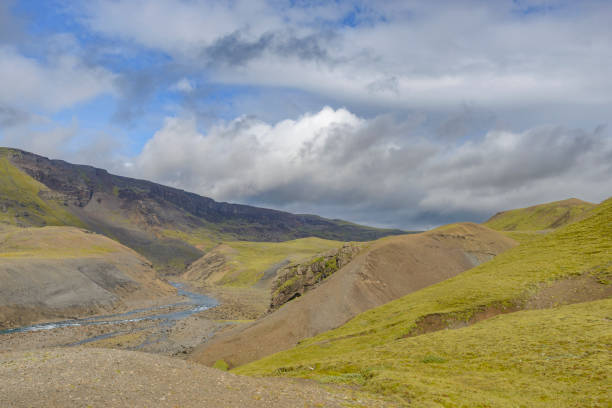 Fossa River valley in Iceland during summer with various creeks running towards the ocean. The vast empty landscape is covered with a dramatic overcast sky.
