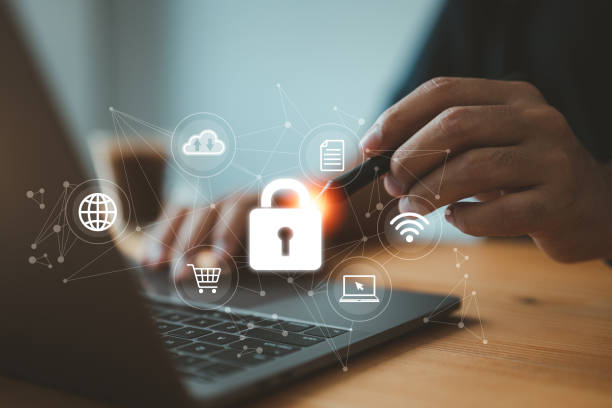 istock businessman using his laptop to establish a network connection that is protected by a shield guard, which safeguards against cyber attacks. This exemplifies the concept of network security systems. 1468532675