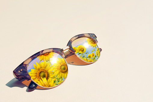 Sun flowers reflection in sunglass. eyesight for summer travel destination.