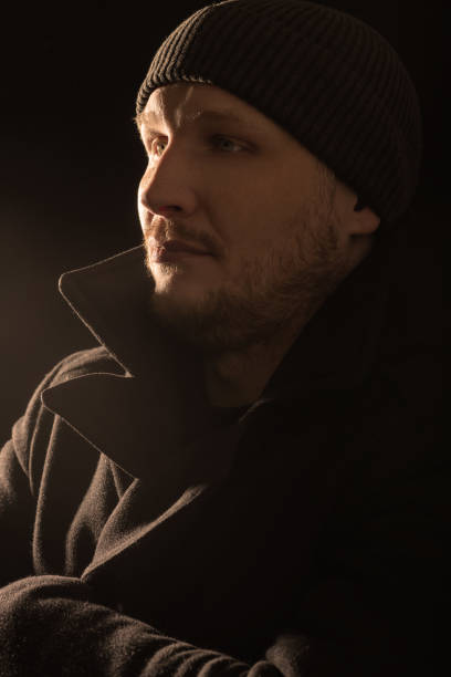 istock Serious man with black winter coat studio portrait in glitch and RGB color split effect style 1468536360