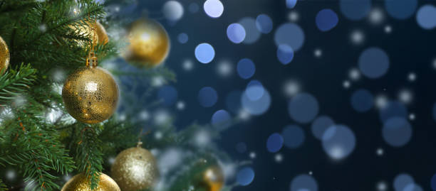 istock Beautiful Christmas tree with bright baubles against blurred lights on dark blue background, closeup. Banner design with space for text 1468536557