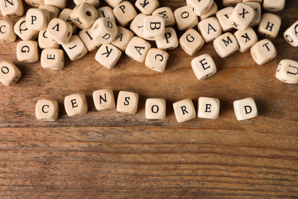 istock Small cubes with word Censored on wooden table, flat lay 1468536743