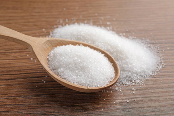istock Granulated sugar and spoon on wooden table, closeup 1468536974